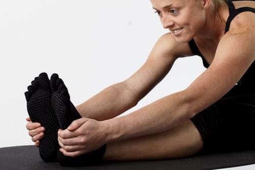Product Clothing Photography | Melbourne Photography | Close up of woman stretching wearing black yoga socks