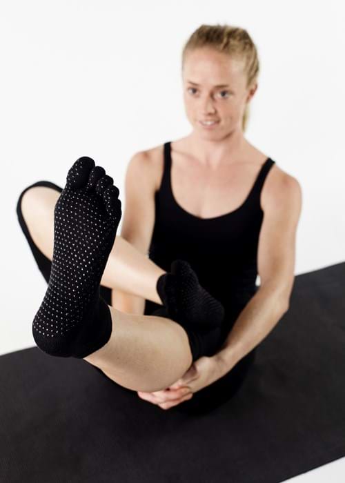 Product Clothing Photography | Melbourne Photography | Woman wearing black yoga socks stretching